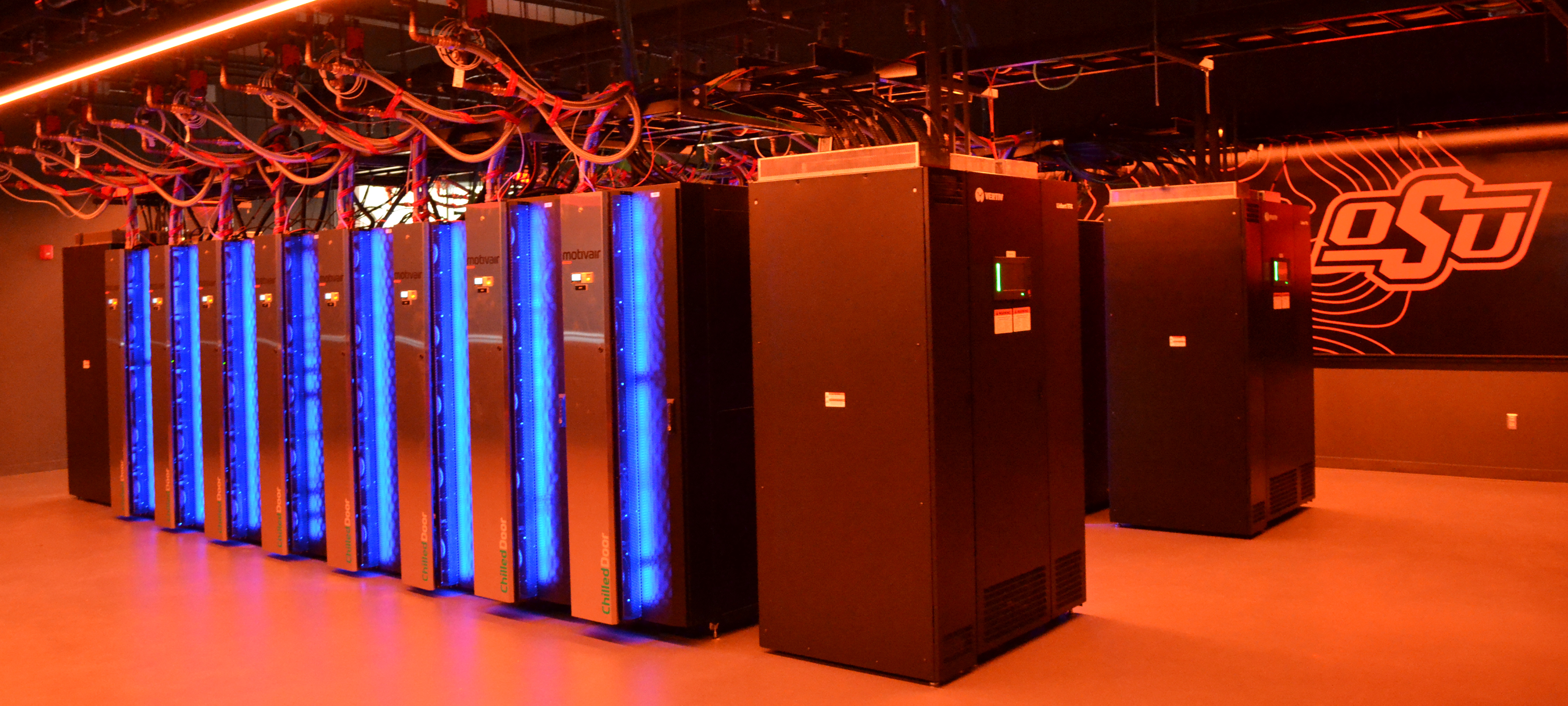 The Cimarron computer is glowing orange. The OSU logo is in the background.